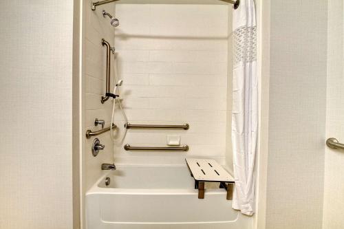 a white bathroom with a tub and a shower at Hampton Inn Clarksdale, Ms in Clarksdale
