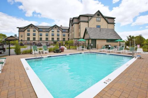 a swimming pool in front of a large building at Hampton Inn Bar Harbor in Bar Harbor