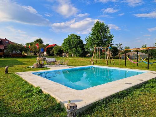 - une piscine dans une cour avec une aire de jeux dans l'établissement Glamping Agapia Agapescu, à Agapia