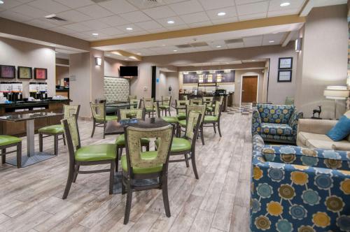 a waiting room with tables and chairs in a hospital at Hampton Inn Hernando, MS in Hernando