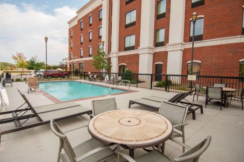 a patio with a table and chairs and a pool at Hampton Inn Hernando, MS in Hernando