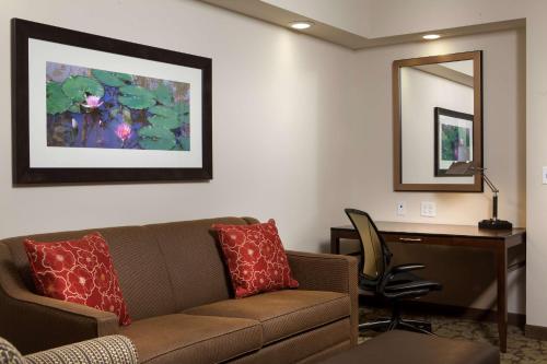 a living room with a couch and a desk at Hilton Garden Inn Bettendorf/ Quad Cities in Bettendorf