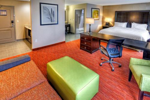 a hotel room with a bed and a desk and chair at Hampton Inn and Suites Ada in Ada