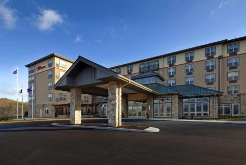 a hotel with a large building in front of it at Hilton Garden Inn Roanoke in Roanoke