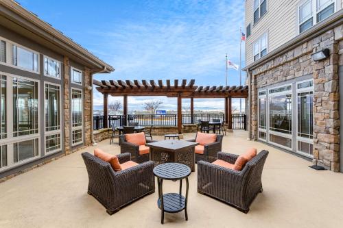 un patio con sillas y mesas en un edificio en Hilton Garden Inn Roanoke, en Roanoke