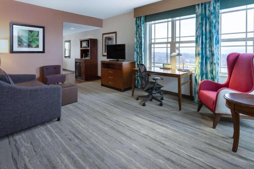 a living room with a couch and a desk at Hilton Garden Inn Roanoke in Roanoke