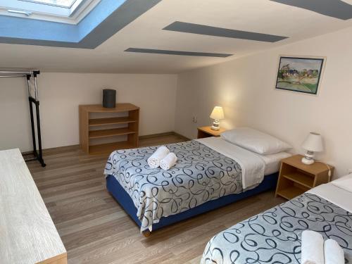 a bedroom with two beds and a blue ceiling at Apartmans and Rooms Madunic M in Split