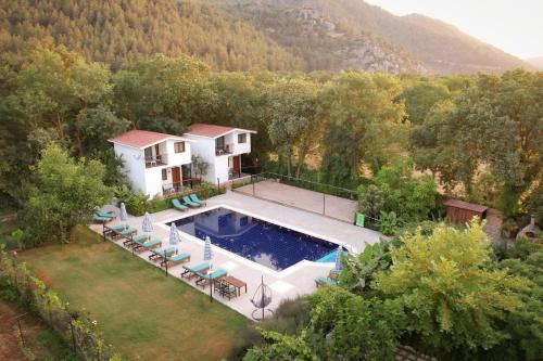 an aerial view of a house with a swimming pool at Pyramid Boutique Hotel in Kayakoy