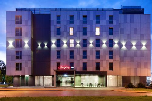 a rendering of a building at night at Hampton by Hilton Krakow in Kraków