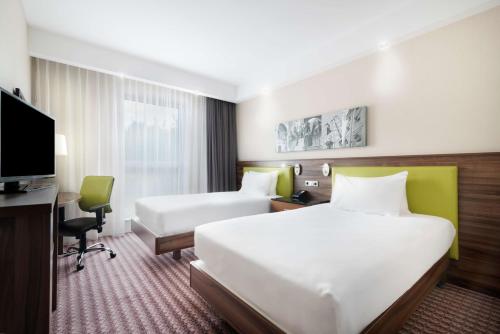 A bed or beds in a room at Hampton by Hilton Krakow