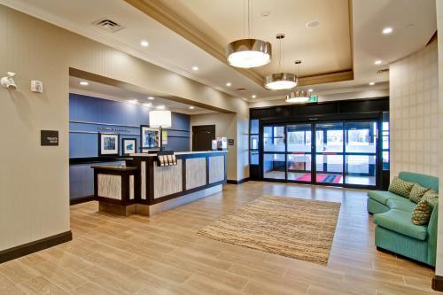 a lobby of a hospital with a couch and a table at Hampton Inn & Suites by Hilton Saskatoon Airport in Saskatoon