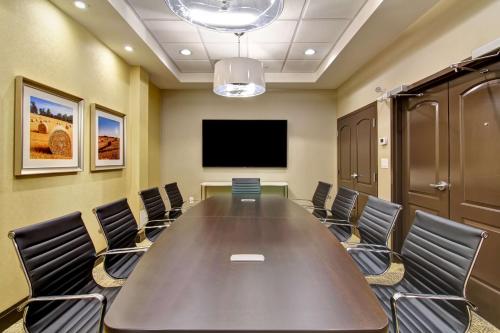 a conference room with a large table and chairs at Hampton Inn & Suites by Hilton Saskatoon Airport in Saskatoon