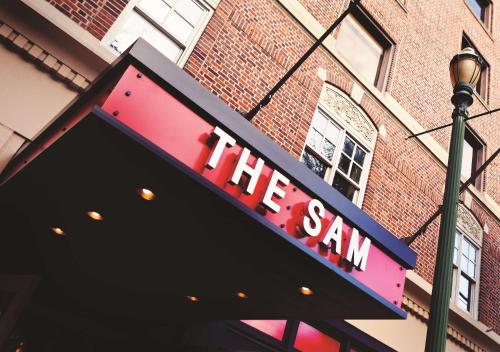 a sign that reads the san on a building at The Sam Houston Hotel, Curio Collection by Hilton in Houston