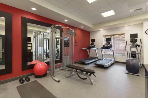 a gym with cardio equipment and a red wall at Hilton Garden Inn Wallingford/Meriden in Wallingford