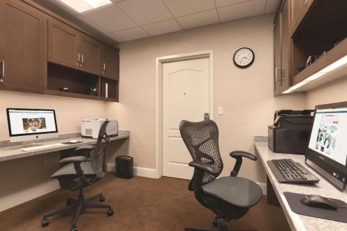 an office with two chairs and a desk with a computer at Hilton Garden Inn Wallingford/Meriden in Wallingford