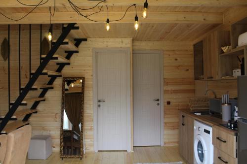 a kitchen with a staircase in a log cabin at mood villa Kazbegi in Stepantsminda