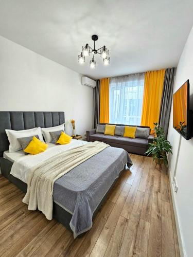 a bedroom with a large bed and a couch at 153 Красивые Апартаменты ЖК Абая 130 in Almaty