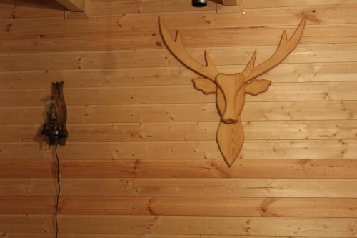 a wall with a deer head with antlers on it at mood villa Kazbegi in Stepantsminda
