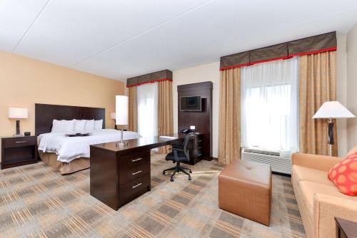 a hotel room with a bed and a desk at Hampton Inn & Suites California University-Pittsburgh in Coal Center