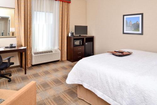 a hotel room with a bed and a desk at Hampton Inn & Suites California University-Pittsburgh in Coal Center