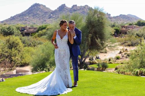 a bride and groom are posing for a picture at Boulders Resort & Spa Scottsdale, Curio Collection by Hilton in Scottsdale