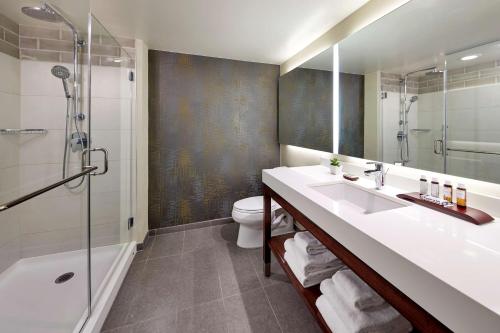 a bathroom with a sink and a shower and a toilet at Hilton Garden Inn San Diego Old Town/Sea World Area in San Diego