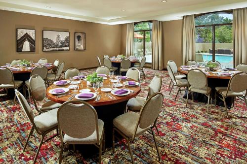 a conference room with tables and chairs and windows at Hilton Garden Inn San Diego Old Town/Sea World Area in San Diego
