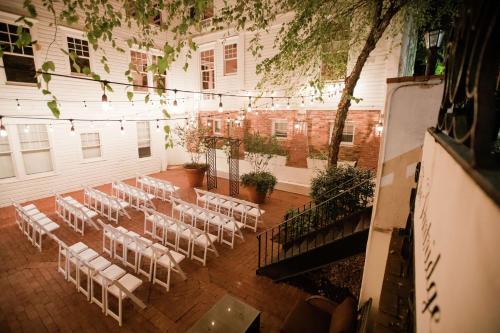 a room with a bunch of white chairs and a building at The Partridge Inn Augusta, Curio Collection by Hilton in Augusta