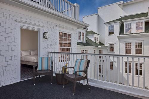 a balcony of a house with two chairs and a bed at The Partridge Inn Augusta, Curio Collection by Hilton in Augusta