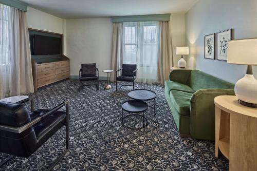 a living room with a couch and a television at The Partridge Inn Augusta, Curio Collection by Hilton in Augusta