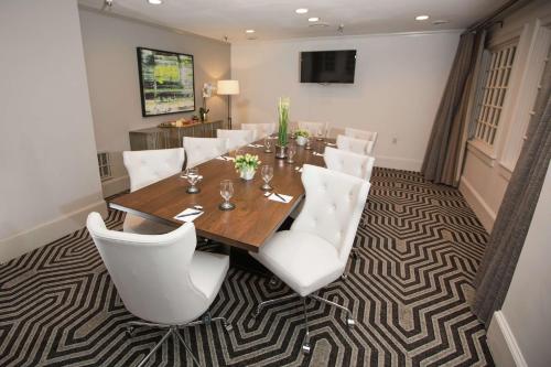 a dining room with a table and white chairs at The Partridge Inn Augusta, Curio Collection by Hilton in Augusta