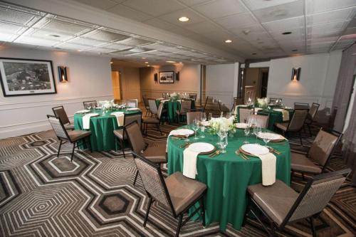 a banquet room with green tables and chairs at The Partridge Inn Augusta, Curio Collection by Hilton in Augusta