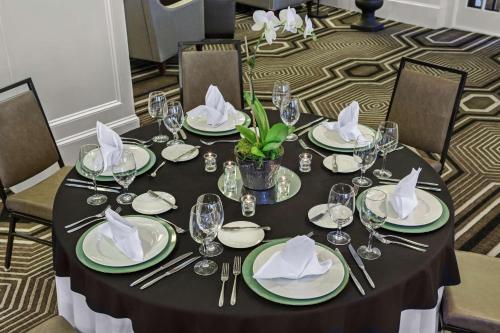 a table with plates and napkins on top at The Partridge Inn Augusta, Curio Collection by Hilton in Augusta