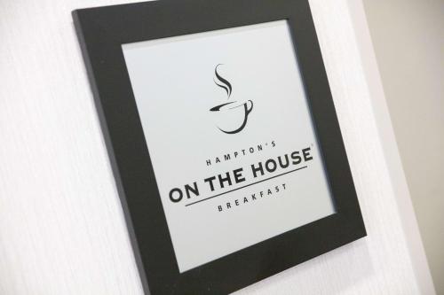 a black picture frame with a signature on the house at Hampton Inn Toledo Oregon in Oregon