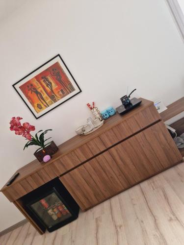 a living room with a wooden table with a fireplace at Apartmani relax in Leskovac