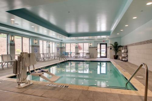 a pool in a building with a swimming pool at Hampton Inn & Suites Greenville Airport in Greenville