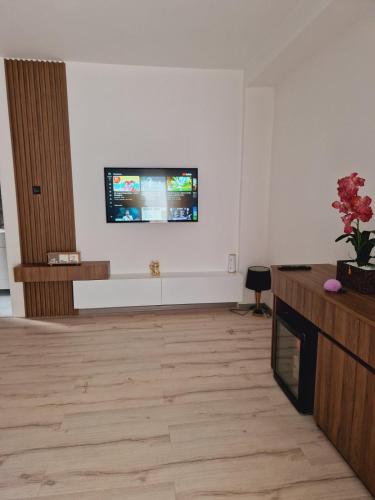 a living room with a flat screen tv on the wall at Apartmani relax in Leskovac