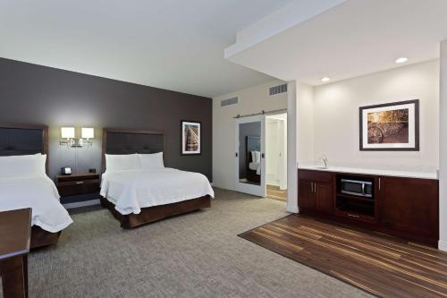 a large hotel room with two beds and a desk at Hampton Inn & Suites - Richmond - Downtown, VA in Richmond