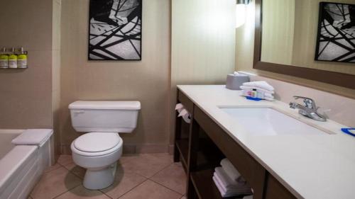 a bathroom with a toilet and a sink and a tub at Holiday Inn Express Vancouver-Metrotown (Burnaby) in Burnaby