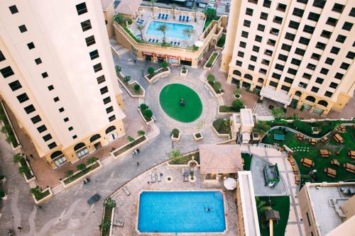 an overhead view of a pool in the middle of two buildings at 96 Hostel Dubai in Dubai