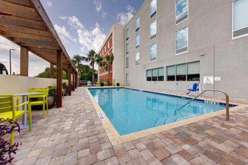 a swimming pool in front of a building at Home2 Suites by Hilton Orlando International Drive South - Free Shuttle to Theme Parks in Orlando