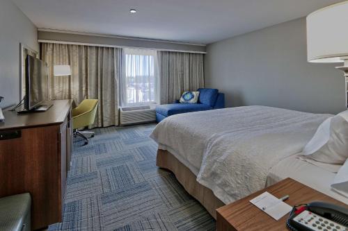 ラスクルーセスにあるHampton Inn & Suites Las Cruces I-10, Nmのベッドとテレビが備わるホテルルームです。