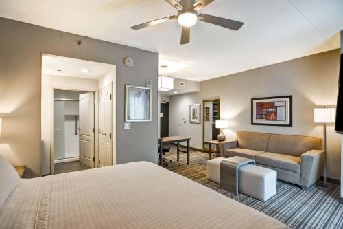 a hotel room with a bed and a living room at Homewood Suites by Hilton Nashville Franklin in Franklin