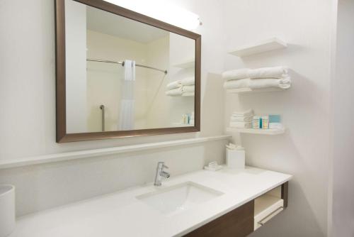 a bathroom with a sink and a mirror and towels at Hampton Inn & Suites Stillwater West in Stillwater