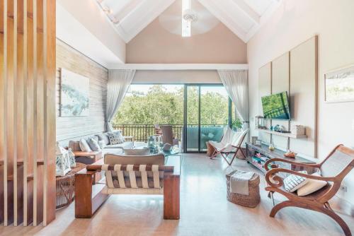 a living room filled with furniture and a large window at Nearby beach and beach club at Portillo NF in Las Terrenas