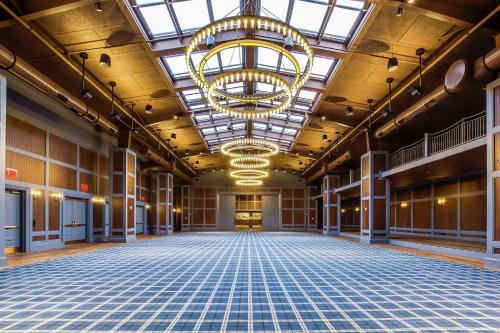 an empty ballroom with a large chandelier in a building at The Campbell House Lexington, Curio Collection by Hilton in Lexington