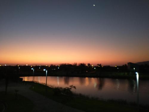 a sunset over a body of water at night at Recanto da Lagoa Flat in Ilha Comprida
