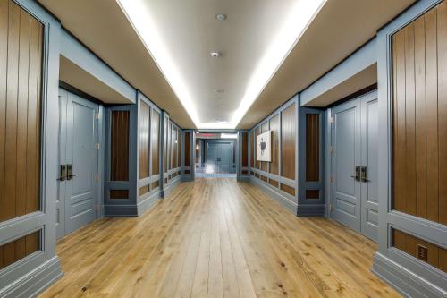 an empty hallway with wood floors and a ceiling at The Campbell House Lexington, Curio Collection by Hilton in Lexington