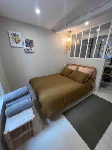 une petite chambre avec un lit et une chaise dans l'établissement Appartement hyper centre Bandol, à Bandol