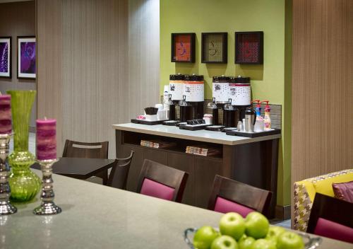 a restaurant with a table and a counter with bottles of wine at Hampton Inn by Hilton Sarnia/Point Edward in Point Edward
